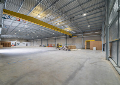 Clear-span warehouse interior with overhead crane, White Rock Road Warrnambool, built by Bolden Constructions